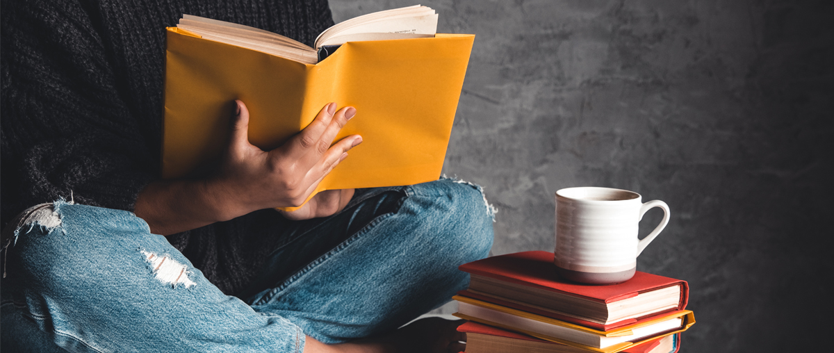 Girl reading a book with coffee