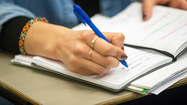 student taking notes