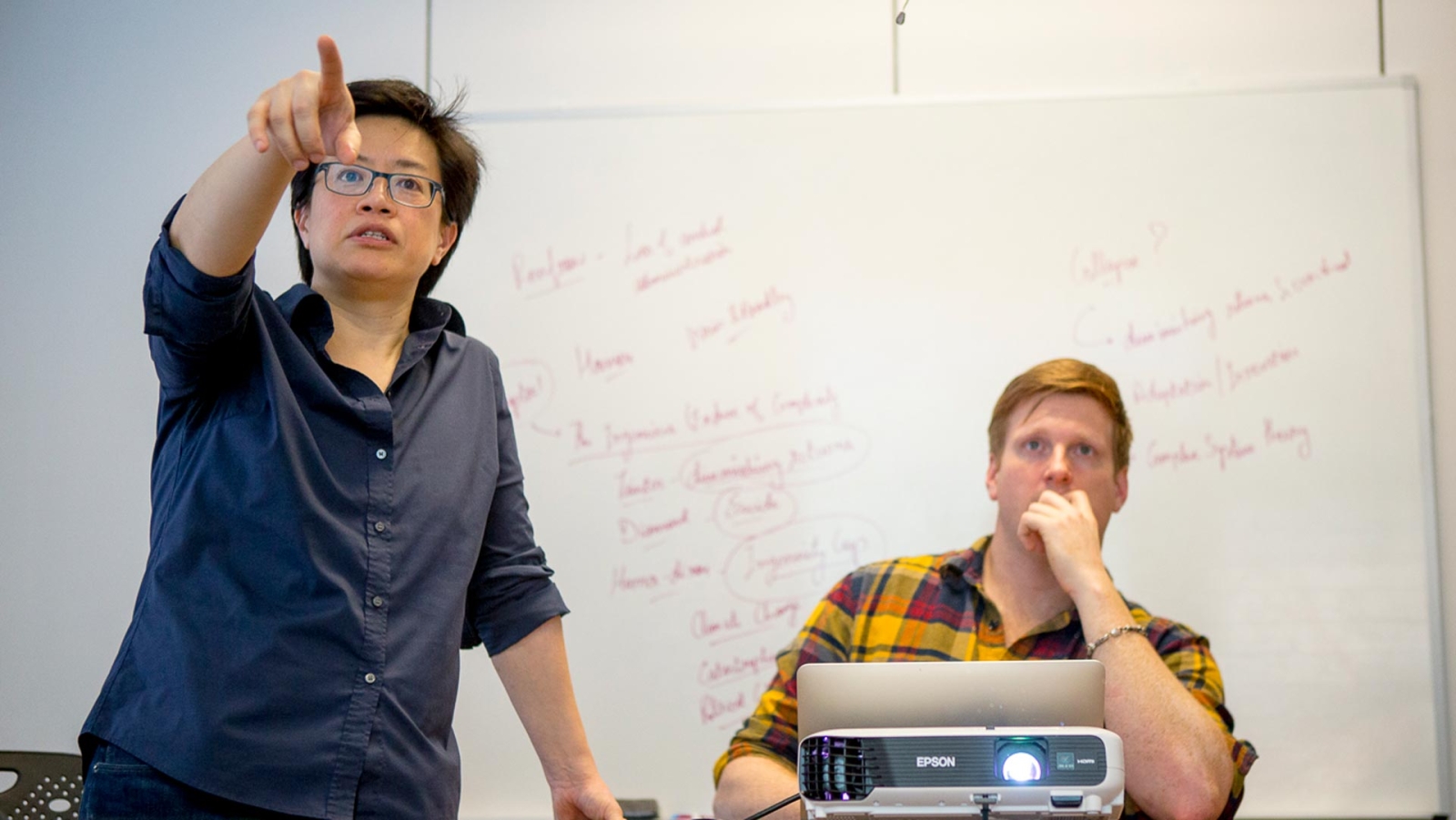 Professor and student looking at data on a screen