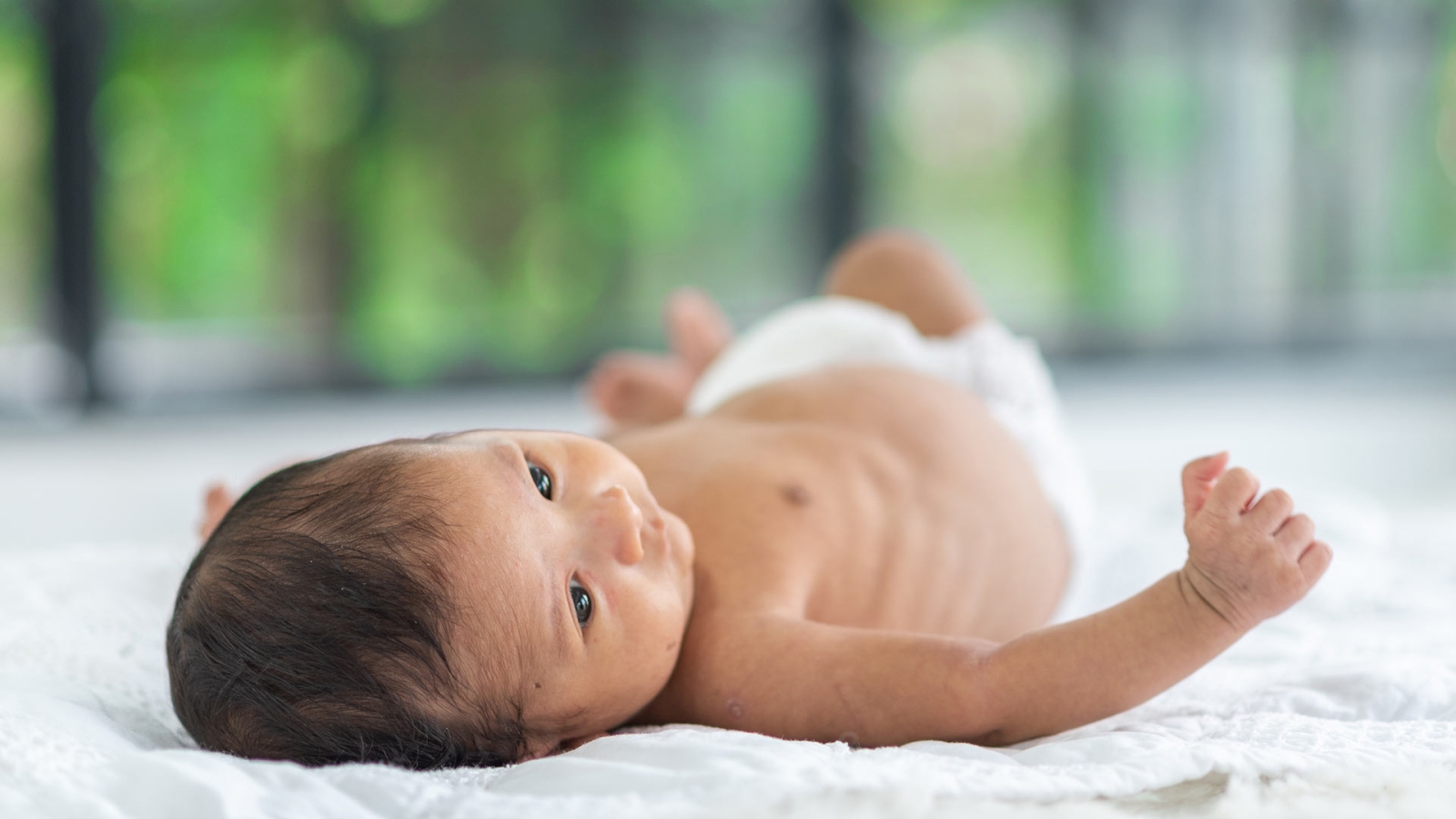 newborn baby on a bed