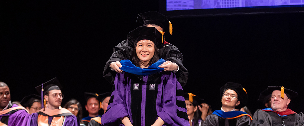 Vivian Wang being hooded by Dr. José Pagán