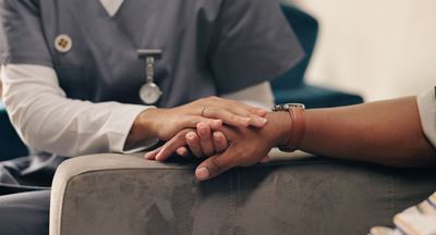 Patient holding hands with nurse