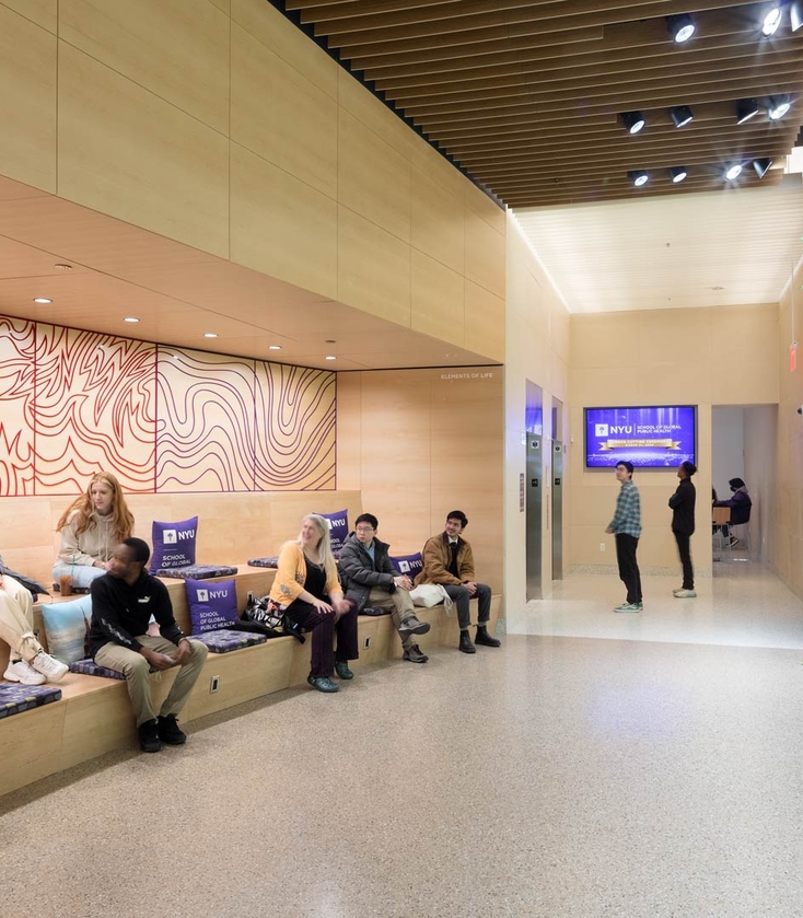 NYU Students in lobby of 708 Broadway in front of the living green wall