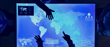 People pointing at a global map