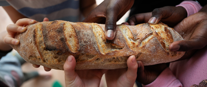 Young hands holding bread