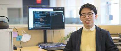Allen Weng sitting at his desk