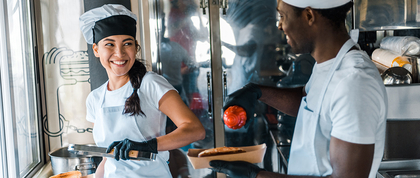 Two chefs working on a food truck