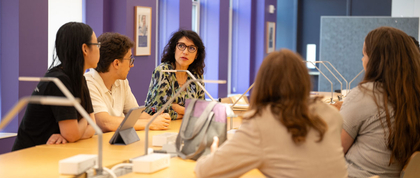 Students meeting with a professor.