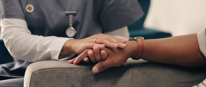 Patient holding hands with nurse