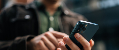 A person typing on their cellphone