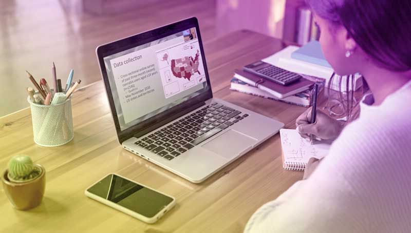 Student working at laptop taking online classes